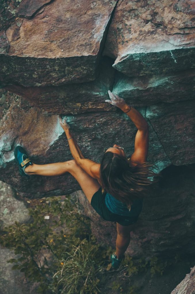 A girl climbing the mountain.