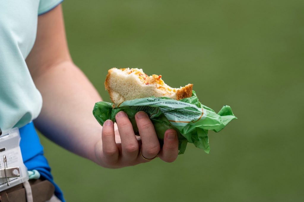 Person holding pimento cheese sandwich