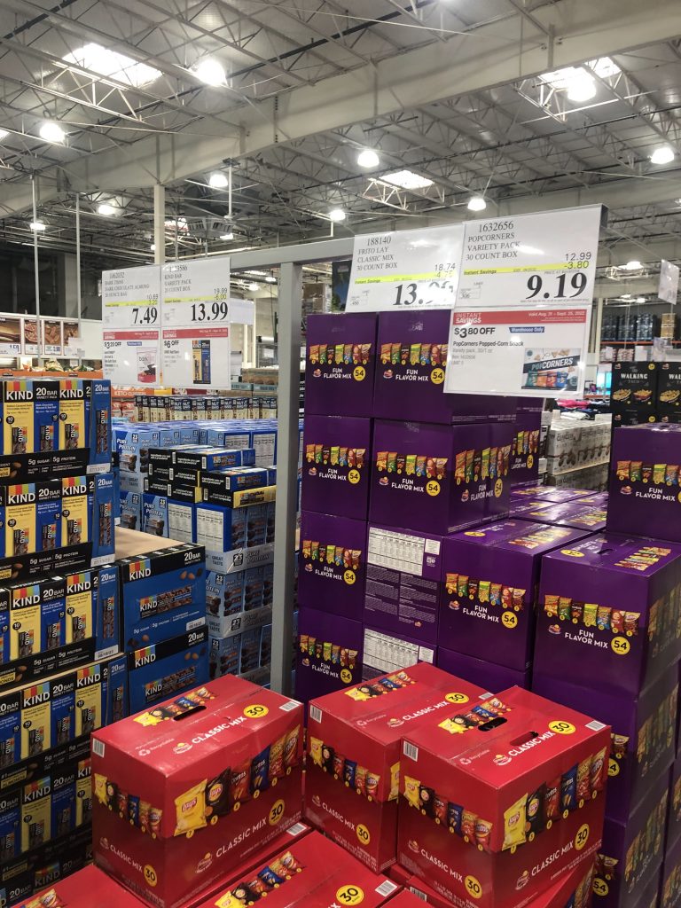 Image displays Costco products with price signs indicating discounted sales.